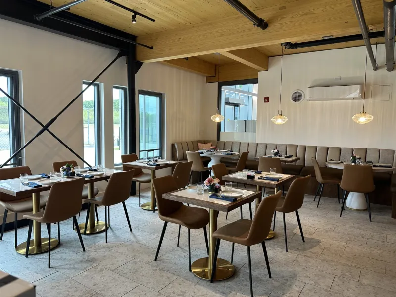 Dining room tables with brass bases and tall windows